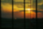 looking-through-window-blinds-sunset-sun